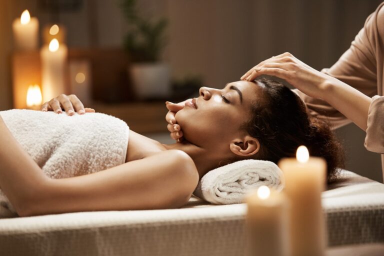 attractive-african-woman-enjoying-face-massage-spa-salon-min